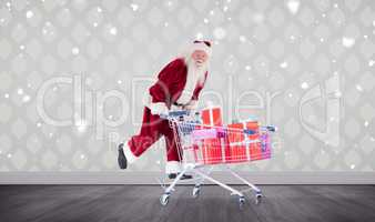 Composite image of santa pushing shopping cart