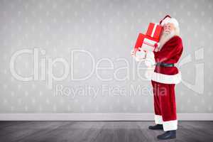 Composite image of santa carrying gifts