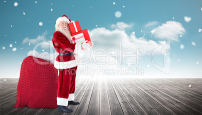 Composite image of santa claus carrying pile of gifts