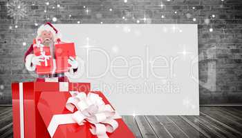 Composite image of santa standing in large gift