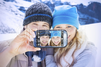 Composite image of hand holding smartphone showing