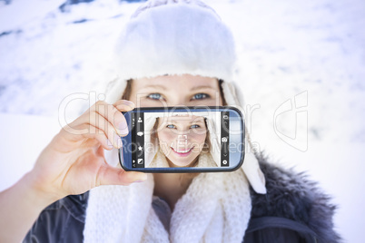 Composite image of hand holding smartphone showing