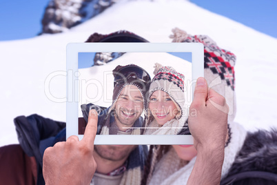 Composite image of hand holding tablet pc