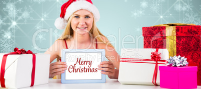 Composite image of festive blonde shopping online with tablet pc