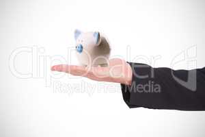 Composite image of businessman holding hand out in presentation