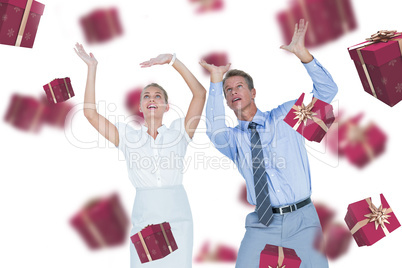 Composite image of business people looking up with hands raised