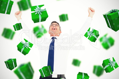 Composite image of excited businessman with glasses cheering