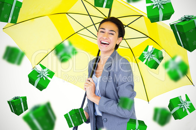 Composite image of portrait of happy businesswoman holding umbre