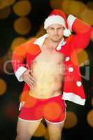 Composite image of muscular man posing in sexy santa outfit