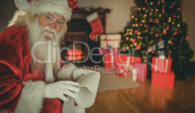 Smiling santa claus holding a scroll