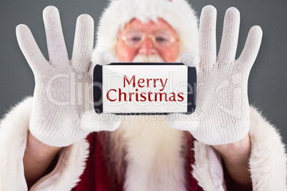 Composite image of santa records himself with a smartphone