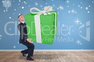 Composite image of stylish man with giant gift