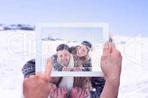 Composite image of hand holding tablet pc