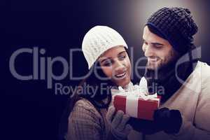 Winter couple holding gift