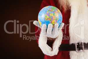 Composite image of santa has a globe in his hand