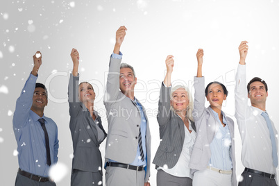Composite image of smiling business people raising hands