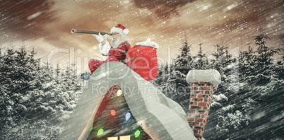 Composite image of santa sitting on roof of cottage