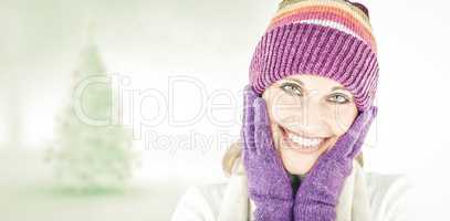 Composite image of radiant young woman with cap and gloves in th