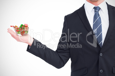 Composite image of businessman holding his hand out