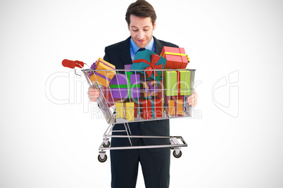 Composite image of businessman holding something with his hands