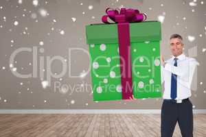 Composite image of stylish man with giant gift