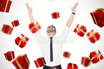 Composite image of smiling businessman cheering with his hands u