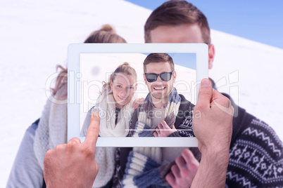 Composite image of hand holding tablet pc