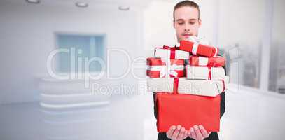 Composite image of concentrated businessman holding out his hand
