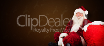 Composite image of santa sits next to his bag