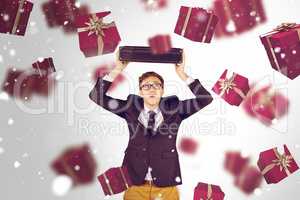 Composite image of young geeky businessman holding briefcase