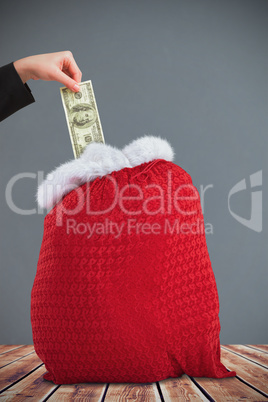 Composite image of businesswomans hand holding hundred dollar bi