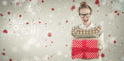 Composite image of excited geeky hipster holding present