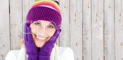 Composite image of radiant young woman with cap and gloves in th