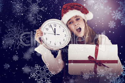 Composite image of festive blonde showing a clock and gift