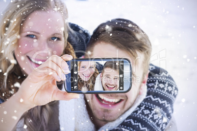 Composite image of hand holding smartphone showing