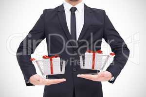 Composite image of mid section of a businessman holding something