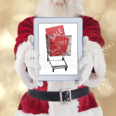 Composite image of santa presents a tablet pc