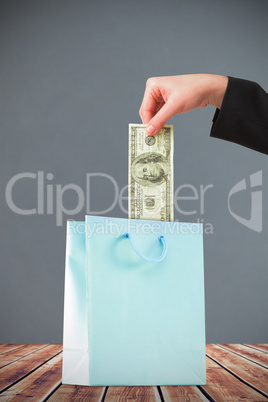 Composite image of businesswomans hand holding hundred dollar bi