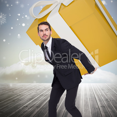 Composite image of stylish man with giant gift