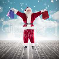 Composite image of santa carrying gifts