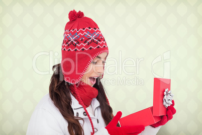 Composite image of happy brown hair opening christmas gift