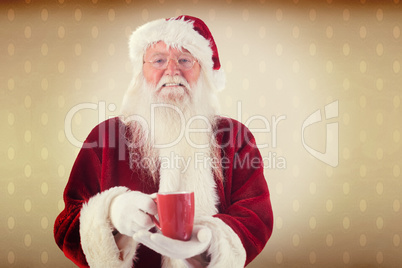 Composite image of santa holds a red cup