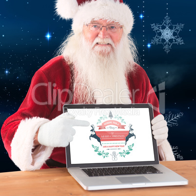 Composite image of happy santa showing laptop screen