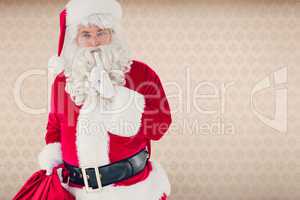 Composite image of santa holding his sack and keeping a secret