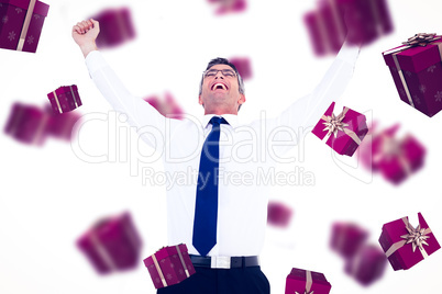 Composite image of excited businessman with glasses cheering