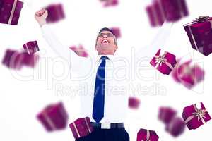 Composite image of excited businessman with glasses cheering