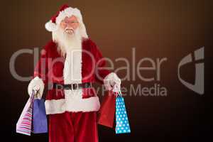 Composite image of santa carries some christmas bags