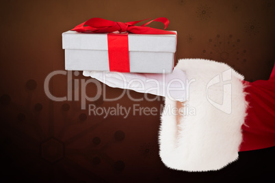 Composite image of santa claus showing gift with red ribbon