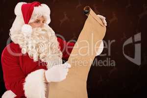 Composite image of santa checking list