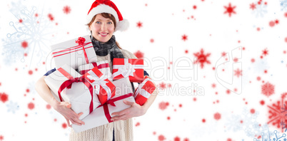 Composite image of woman holding lots of presents